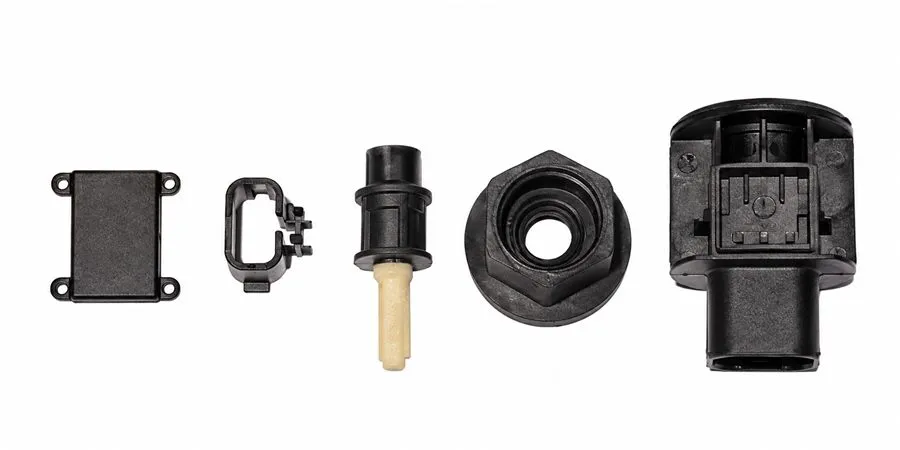 Moulded speed sensor housing components: cover, clip, plunger, nut and connector body