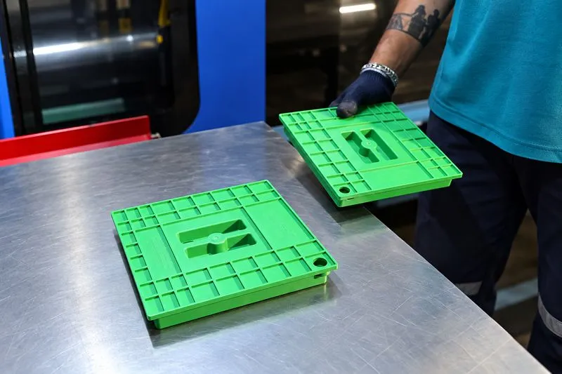 Moulded plastic components beside the machine