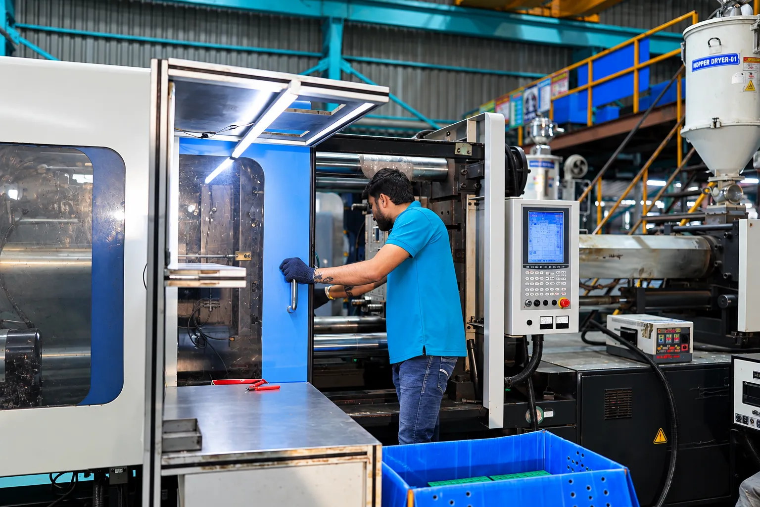 Operator working at an injection moulding machine